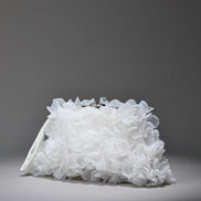 White floral clutch bag on a gray background
