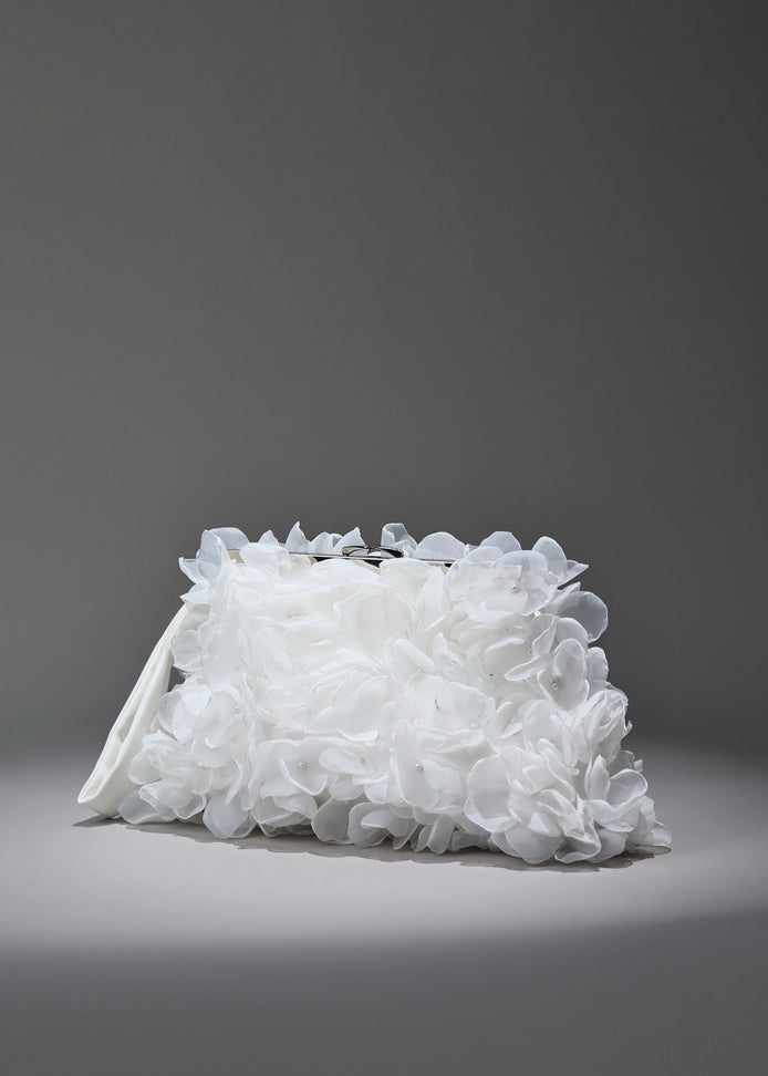 White floral clutch bag on a gray background