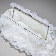 White clutch with ruffled on a gray background