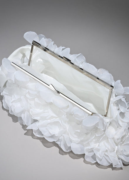 White clutch with ruffled on a gray background