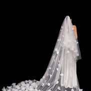 Long white wedding veil with floral details on a black background