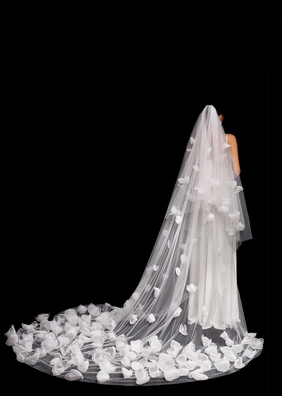 Long white wedding veil with floral details on a black background