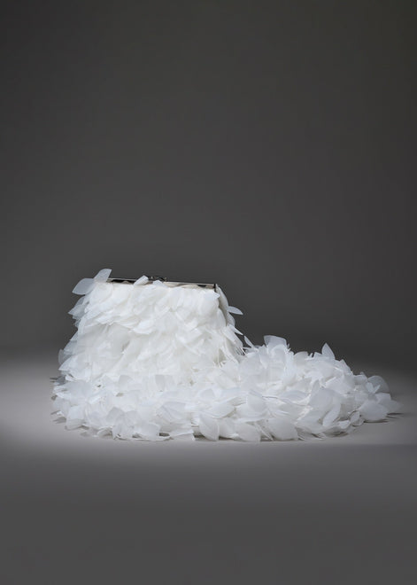 White shoe made of small crystals on a dark gray background