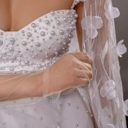 White wedding dress with pearl embellishments and a floral veil CELESTE by Linni Caro