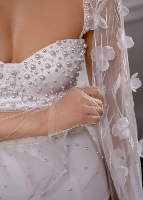 White wedding dress with pearl embellishments and a floral veil CELESTE by Linni Caro