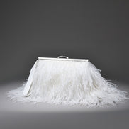 White feathered skirt with a silver frame on a gray background