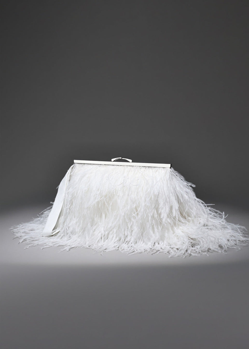 White feathered skirt with a silver frame on a gray background
