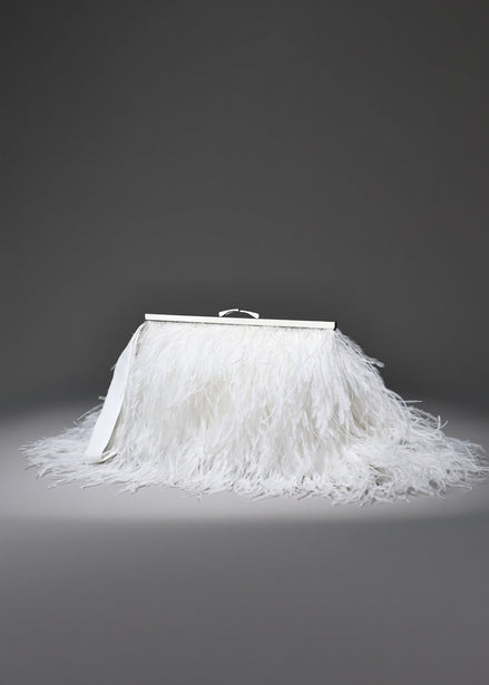 White feathered skirt with a silver frame on a gray background