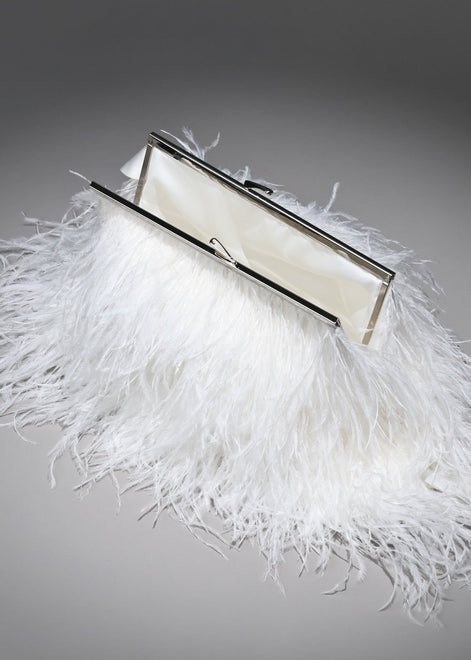 White feathered clutch bag with a silver frame on a gray background