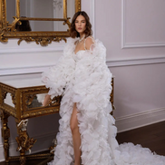 Woman in a white floral gown by Linni Caro