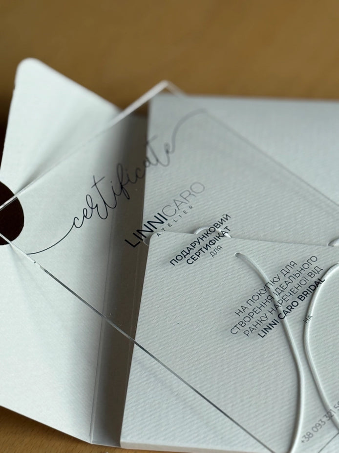 Folded white certificate with black text