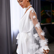 Woman wearing a white floral dress in an indoor setting
