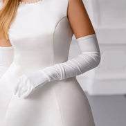 White dress with long gloves on a plain background