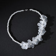 White floral headband on a black background